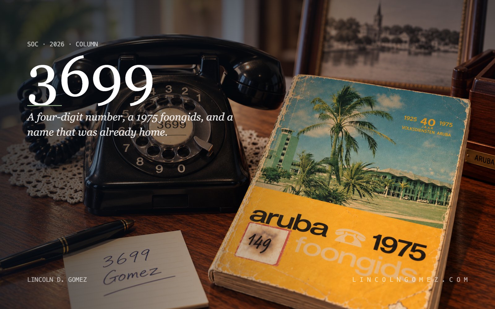 A 1975 Aruba foongids telephone directory lying beside a black rotary dial telephone on a wooden table, with a handwritten card reading 3699 Gomez. Set into the dark left side, the title 3699 and beneath an aloe rule the words A four-digit number, a 1975 foongids, and a name that was already home.