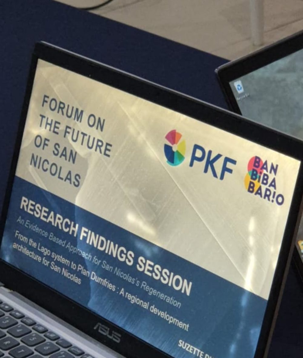 A laptop screen showing the session title slide: Forum on the Future of San Nicolas, Research Findings Session, From the Lago system to Plan Dumfries, a regional development architecture for San Nicolas