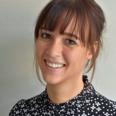 Portrait of a woman in a patterned dark blouse