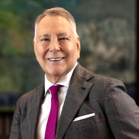 Portrait of a man in a checked suit with a magenta tie